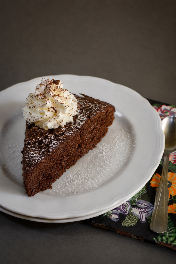 Gâteau au chocolat avec du chocolat en poudre garni de chantilly et légèrement saupoudré de sucre glace