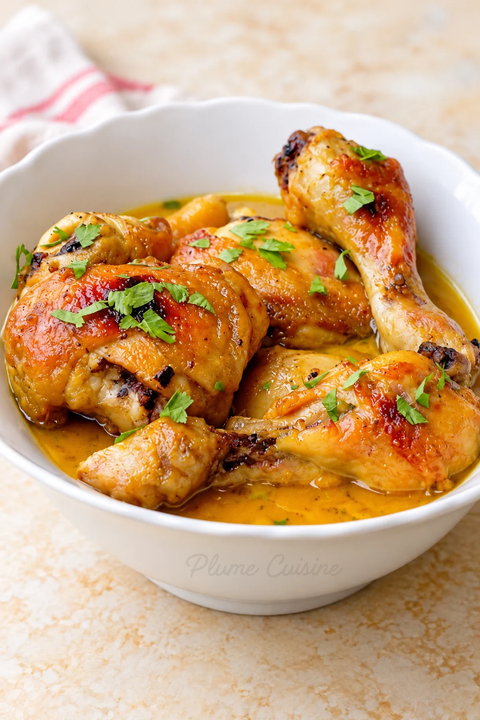 Poulet au miel et à la moutarde servi dans un plat blanc, nappé d’une sauce dorée