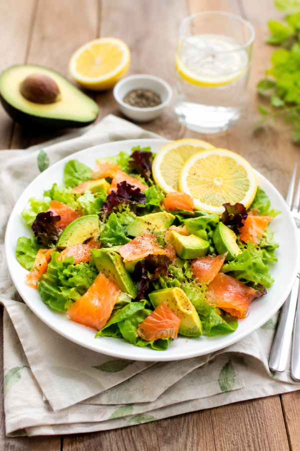 Salade de saumon et avocat présentée dans une assiette blanche.